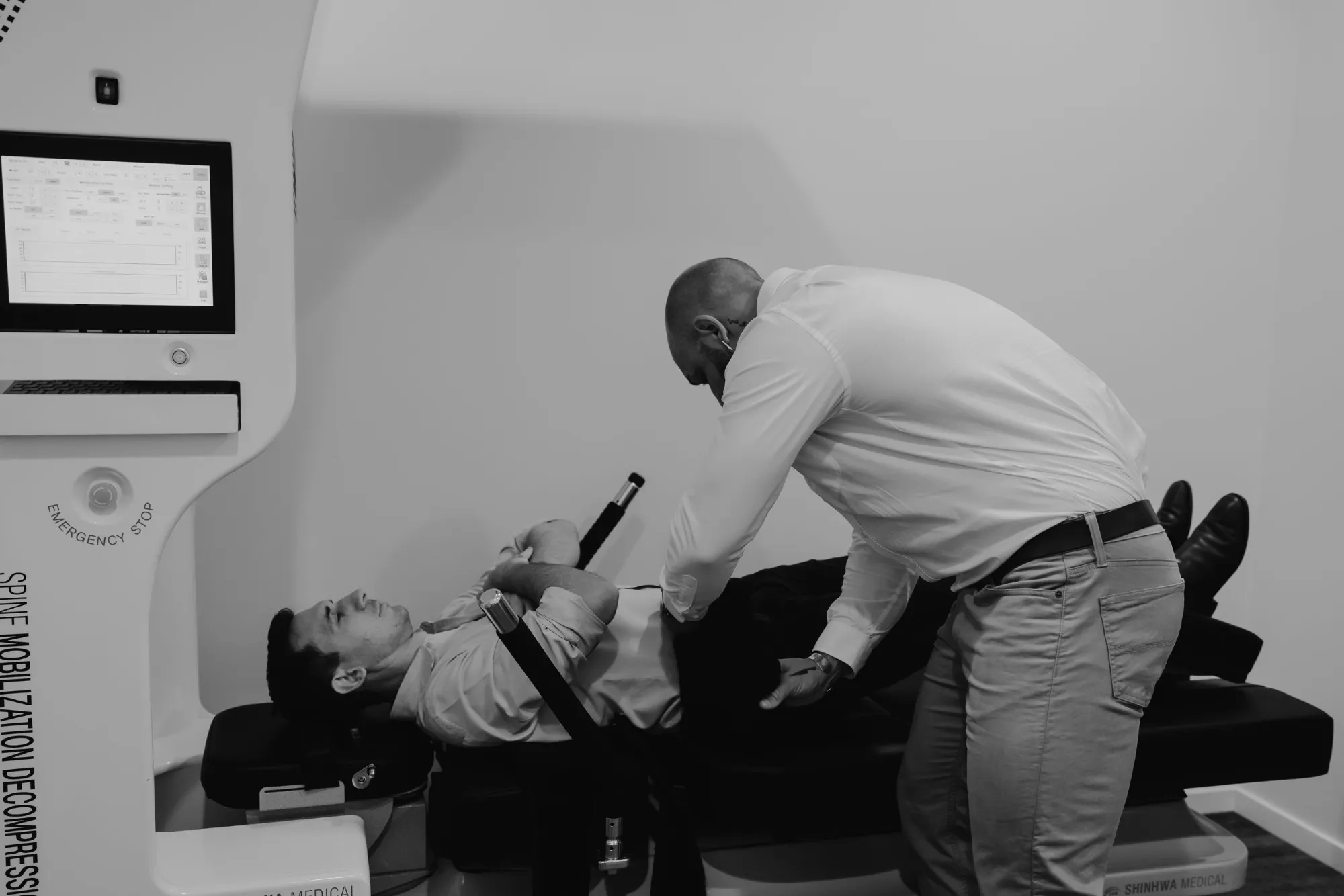 A practitioner setting a patient up on the Spine Series